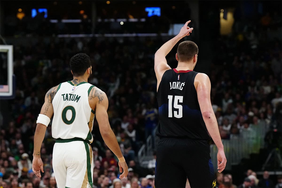 Boston Celtics forward Jayson Tatum (0) and Denver Nuggets center Nikola Jokic (15) during the first half at Ball Arena.