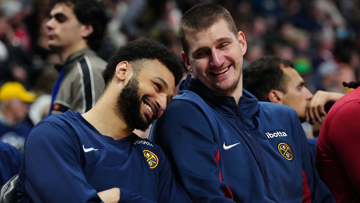 Denver Nuggets center Nikola Jokic (15) and guard Jamal Murray (27) react on the bench during the fourth quarter against the Memphis Grizzlies at Ball Arena. 