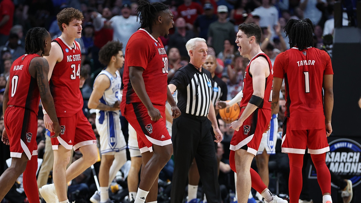  North Carolina State Wolfpack forward DJ Burns Jr. (30) and guard Michael O'Connell (12) react in the second half against the Duke Blue Devils in the finals of the South Regional of the 2024 NCAA Tournament 