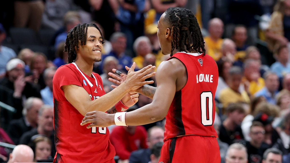 North Carolina State Wolfpack guard Breon Pass (10) celebrates with guard DJ Horne (0) during the second half in the semifinals of the South Regional of the 2024 NCAA Tournament against the Marquette Golden Eagles at American Airlines Center.