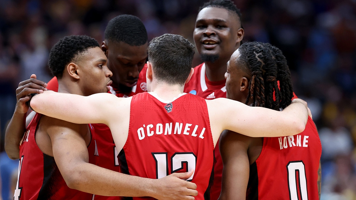 North Carolina State Wolfpack guard Michael O'Connell (12) huddles with teammates during the second half in the semifinals of the South Regional of the 2024 NCAA Tournament against the Marquette Golden Eagles at American Airlines Center