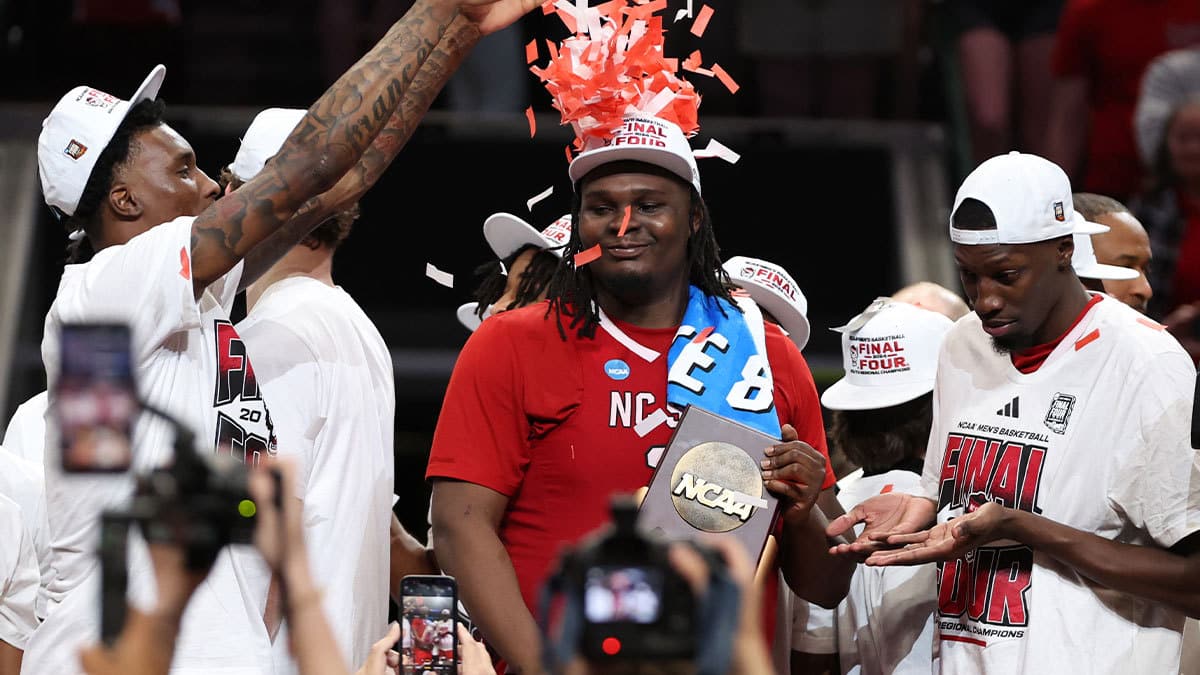 Mar 31, 2024; Dallas, TX, USA; North Carolina State Wolfpack forward DJ Burns Jr. (30) celebrates with the trophy after defeating the Duke Blue Devils in the finals of the South Regional of the 2024 NCAA Tournament at American Airline Center. Mandatory Credit: Tim Heitman-USA TODAY Sports