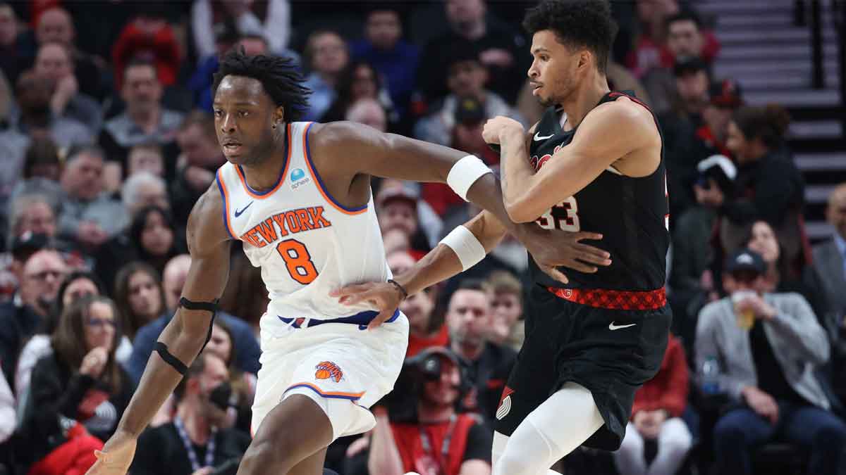 New York Knicks forward OG Anunoby (8) controls the ball against Portland Trail Blazers forward Toumani Camara (33) in the fourth quarter at Moda Center