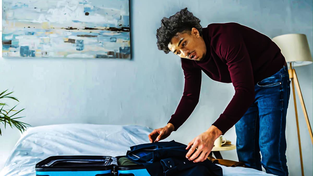 Milos Uzan (Oklahoma basketball) as a man packing his bags