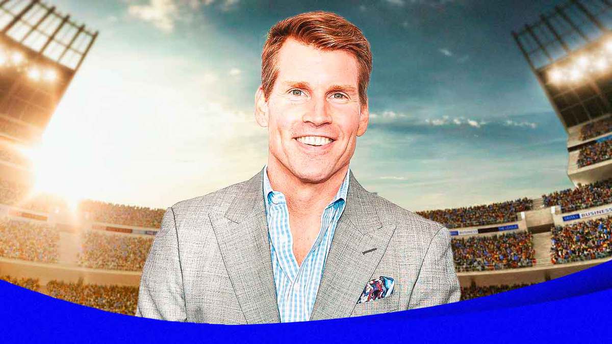 Scott Hanson smiling with olympic logo background.