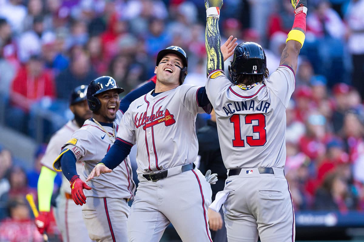 Atlanta Braves outfielder Ronald Acuna Jr. (13) and third baseman Austin Riley (M) and second baseman Ozzie Albies (L) celebrate after scoring during the eighth inning against the Philadelphia Phillies at Citizens Bank Park.
