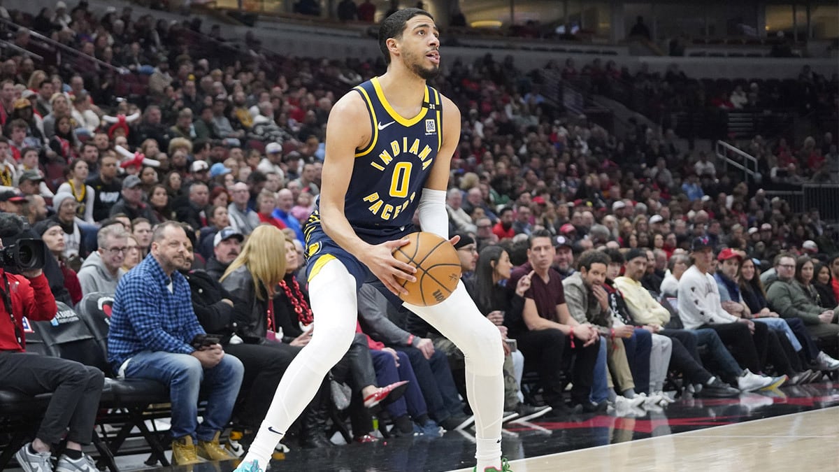 Indiana Pacers guard Tyrese Haliburton (0) sets up for a three point basket against the Chicago Bulls during the first quarter at United Center. 
