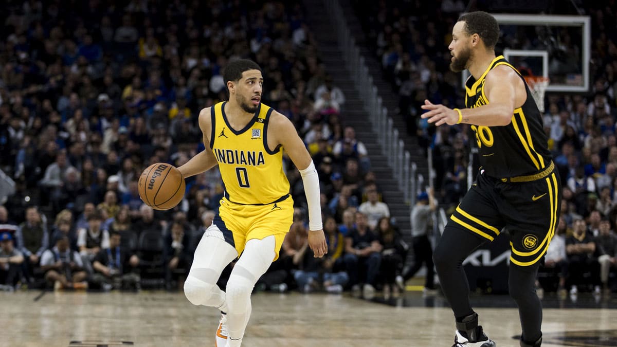 Indiana Pacers guard Tyrese Haliburton (0) looks to pass as Golden State Warriors guard Stephen Curry (30) defends during the second half at Chase Center