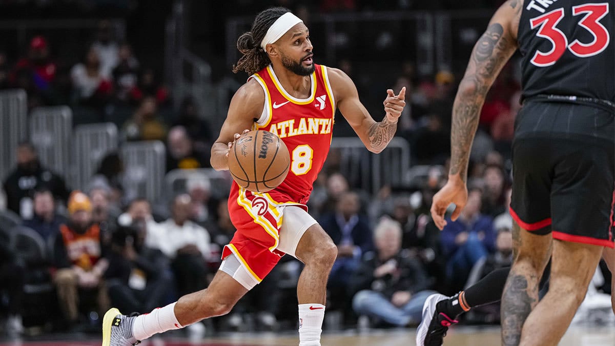 Atlanta Hawks guard Patty Mills (8) brings the ball up the court against the Toronto Raptors during the first half at State Farm Arena. 