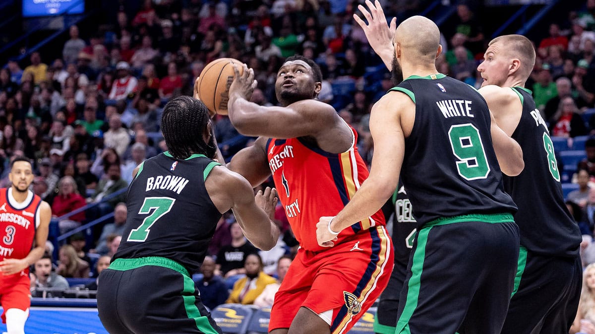 New Orleans Pelicans forward Zion Williamson (1) shoots the ball over Boston Celtics guard Jaylen Brown (7) and guard Derrick White (9) and center Kristaps Porzingis (8) during the second half at Smoothie King Center. 
