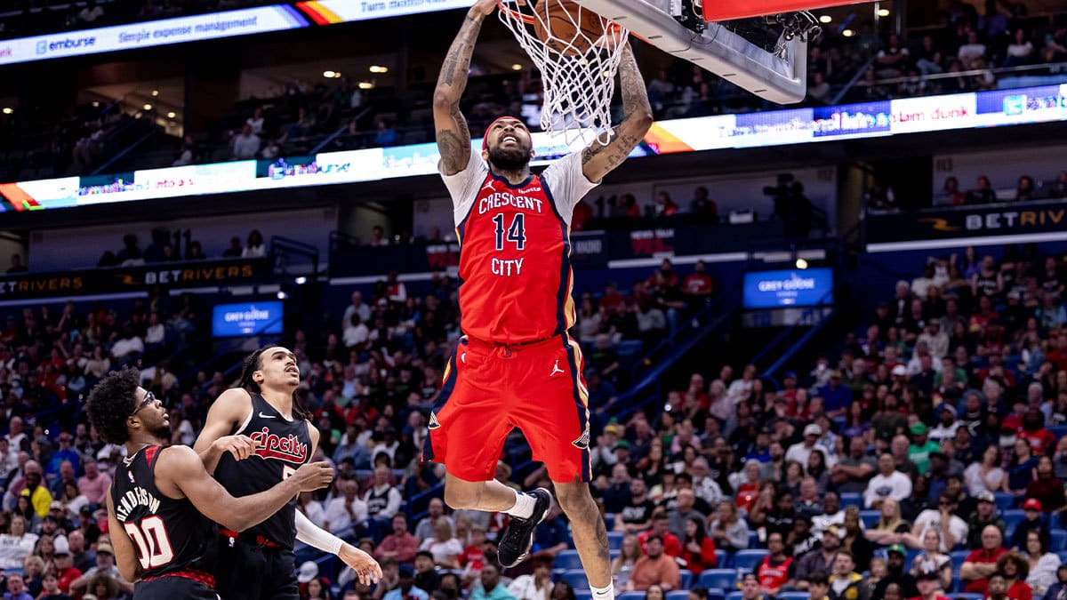 New Orleans Pelicans forward Brandon Ingram (14) dunks the ball against Portland Trail Blazers guard Dalano Banton (5) and guard Scoot Henderson (00) during the second half at Smoothie King Center.