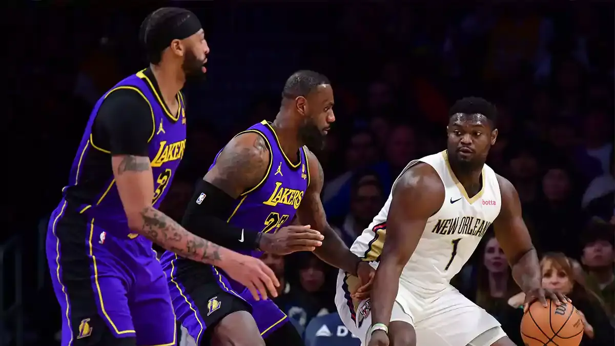 New Orleans Pelicans forward Zion Williamson (1) moves the ball against Los Angeles Lakers forward LeBron James (23) and forward Anthony Davis (3) during the first half at Crypto.com Arena.