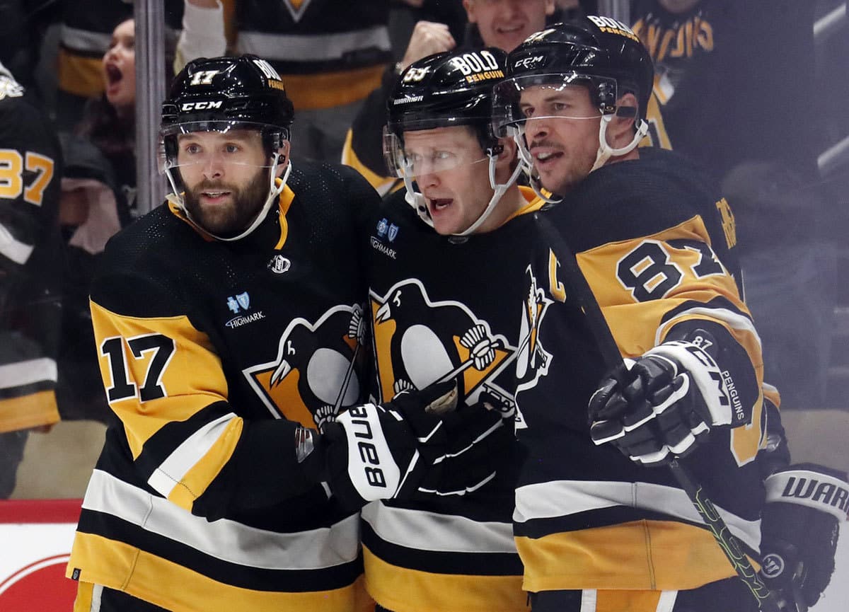  Pittsburgh Penguins left wing Jake Guentzel (middle) celebrates with right wing Bryan Rust (17) and center Sidney Crosby (87) after Guentzel scored a goal against the Montreal Canadiens during the third period at PPG Paints Arena.