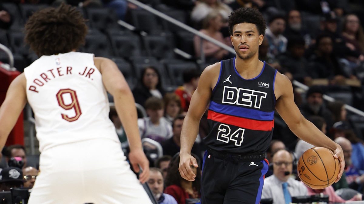 Detroit Pistons guard Quentin Grimes (24) dribbles defended by Cleveland Cavaliers guard Craig Porter (9) 