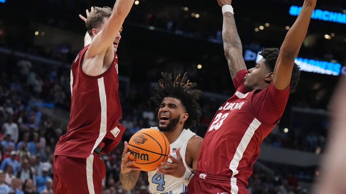North Carolina Tar Heels guard RJ Davis (4) shoots against Alabama Crimson Tide forward Grant Nelson (2) and forward Nick Pringle (23) in the second half in the semifinals of the West Regional of the 2024 NCAA Tournament at Crypto.com Arena.