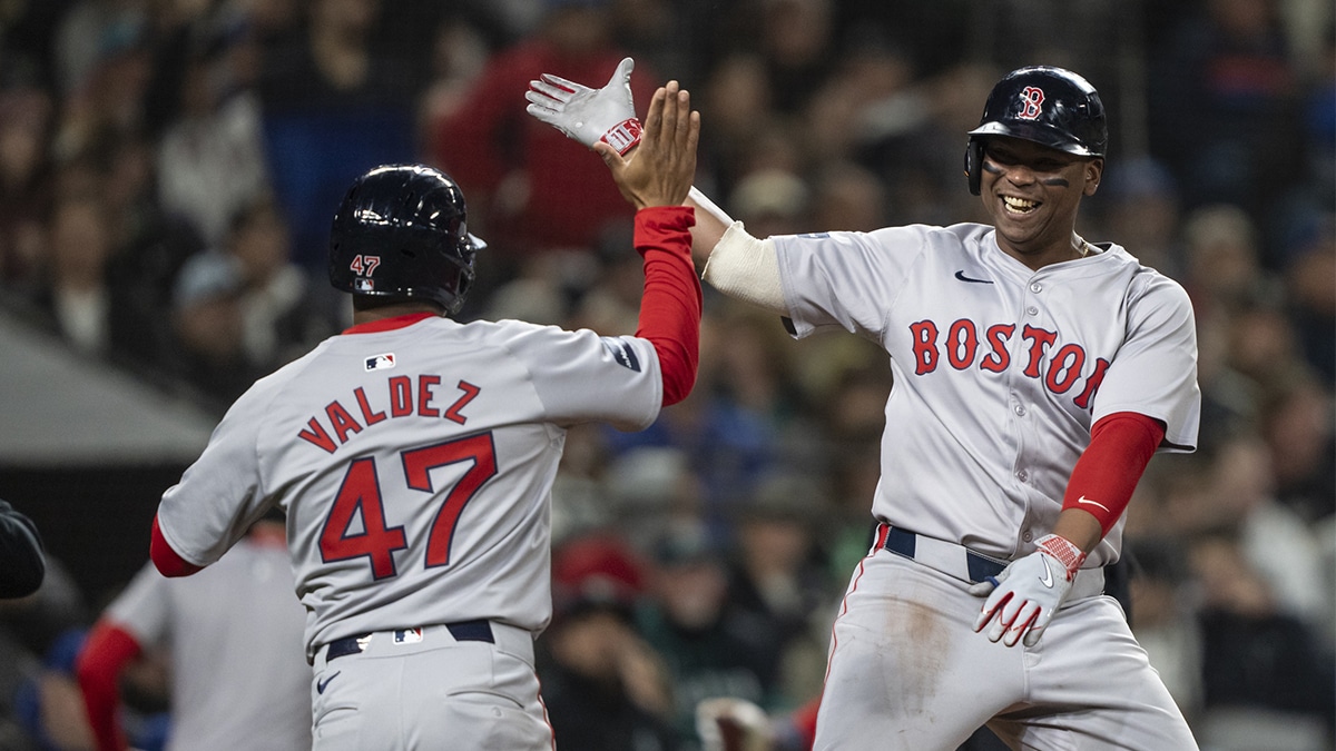Boston Red Sox third baseman Rafael Devers (11) celebrates wiht second baseman Enmanuel Valdez (47) after hitting a two-run home run against the Seattle Mariners during the third inning at T-Mobile Park