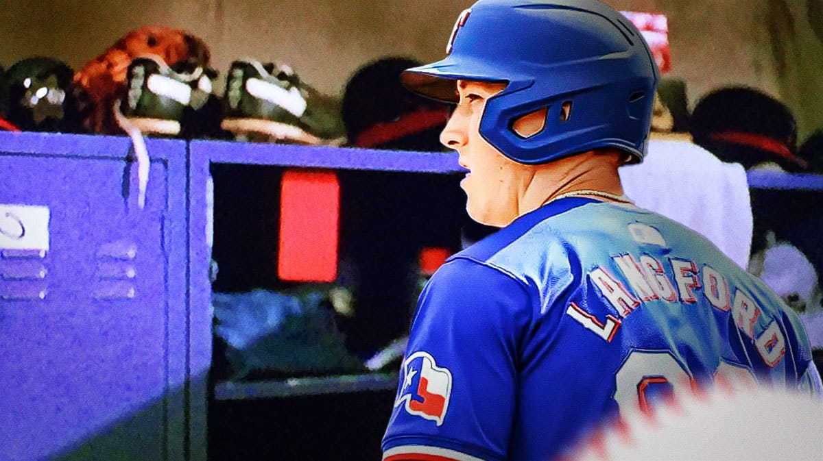 Rangers' Wyatt Langford looking at locker before Opening Day.