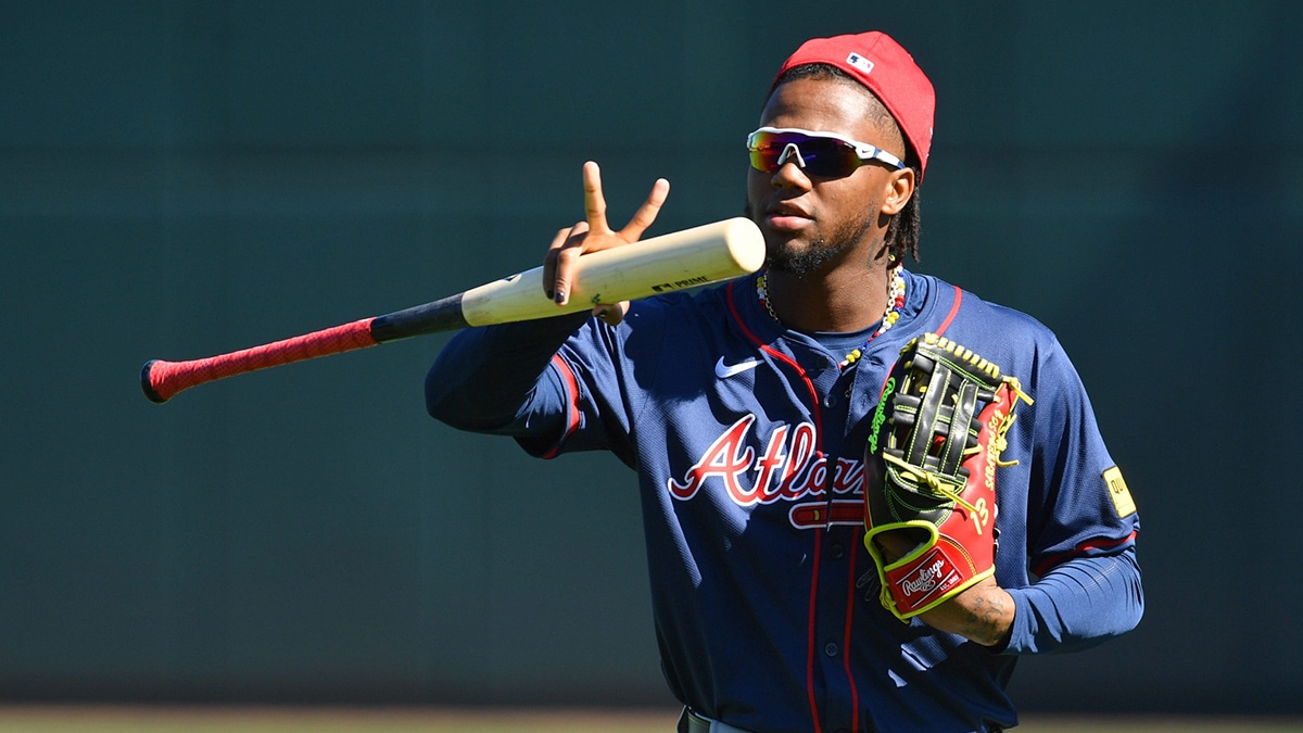 Atlanta Braves outfielder Ronald Acuna, Jr. makes a sign for a video drone following players as the enter the stadium for the first full squad workout on Tuesday,