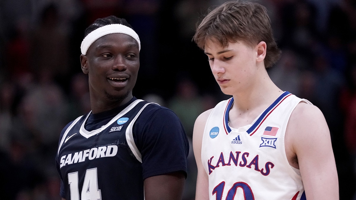Mar 21, 2024; Salt Lake City, UT, USA; Samford Bulldogs forward Achor Achor (14) talks to Kansas Jayhawks guard Johnny Furphy (10) during the second half in the first round of the 2024 NCAA Tournament at Vivint Smart Home Arena-Delta Center. Mandatory Credit: Gabriel Mayberry-USA TODAY Sports