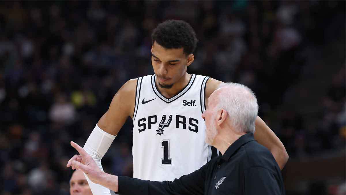 San Antonio Spurs center Victor Wembanyama (1) and head coach Gregg Popovich speak during a break in action against the Utah Jazz during the third quarter at Delta Center. 