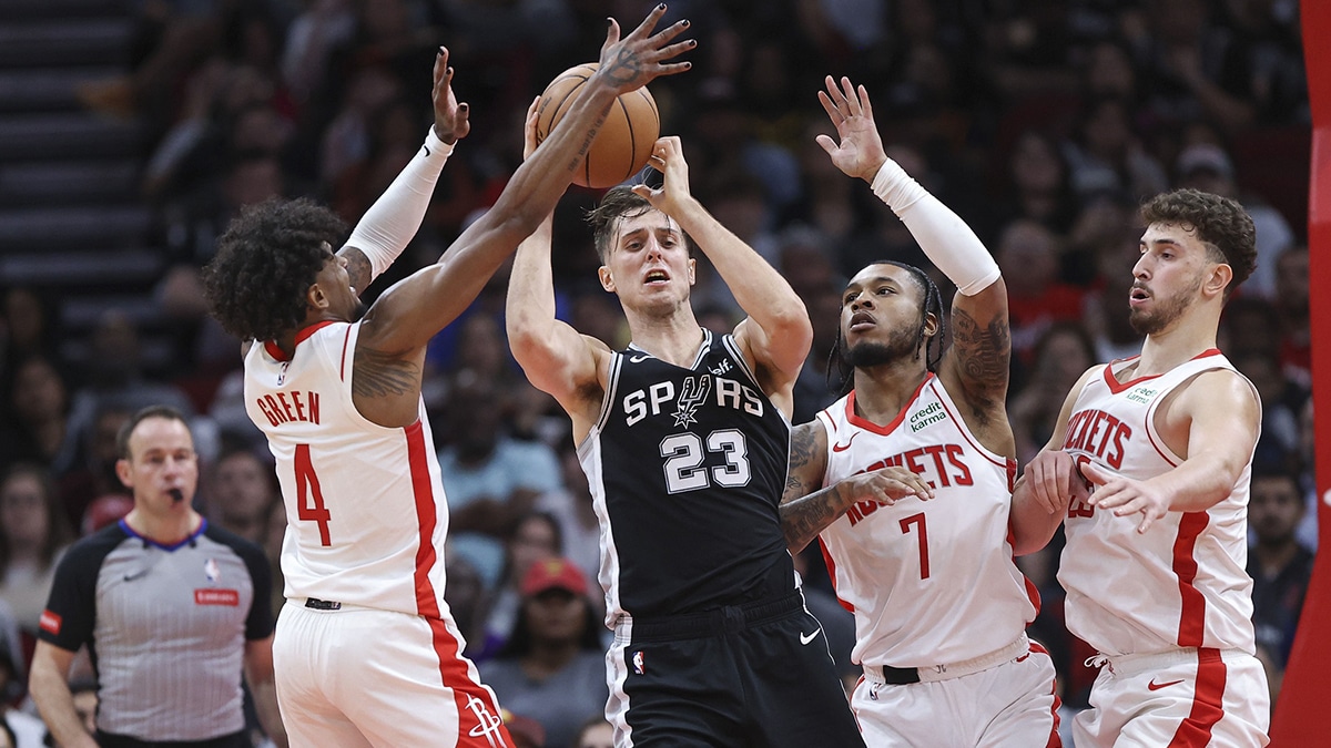 San Antonio Spurs forward Zach Collins (23) looks to pass the ball as Houston Rockets guard Jalen Green (4) defends during the fourth quarter at Toyota Center. 