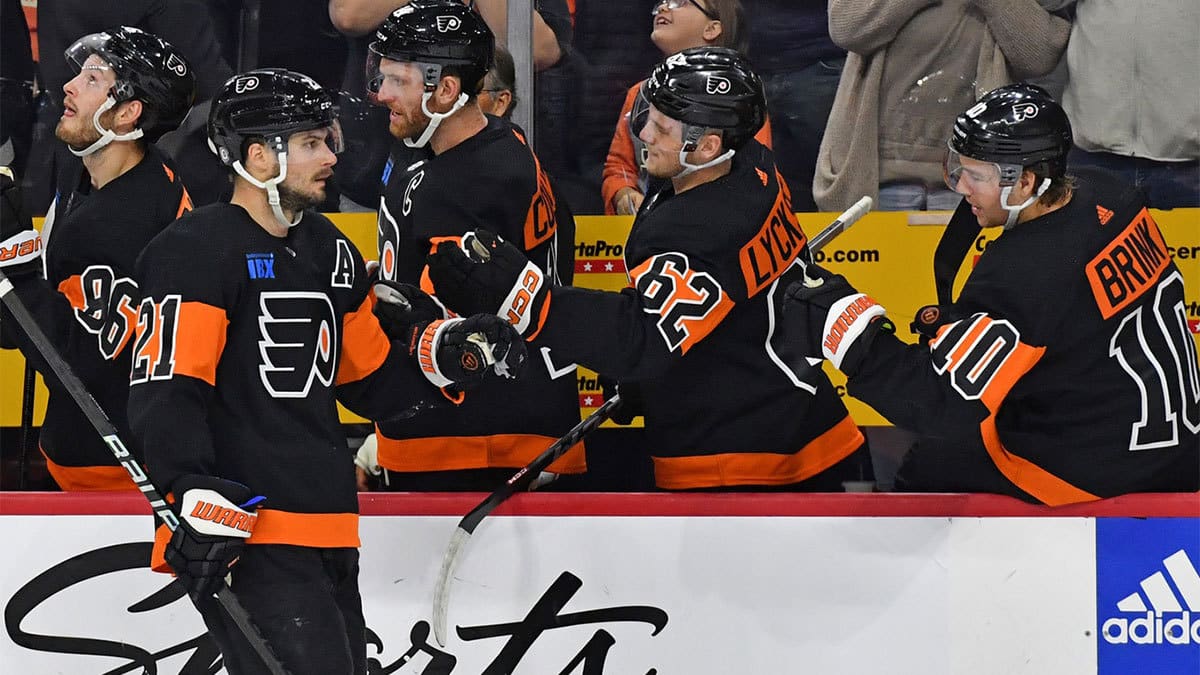 Philadelphia Flyers center Scott Laughton (21) celebrates his goal with right wing Olle Lycksell (62) and right wing Bobby Brink (10) against the St. Louis Blues during the first period at Wells Fargo Center.