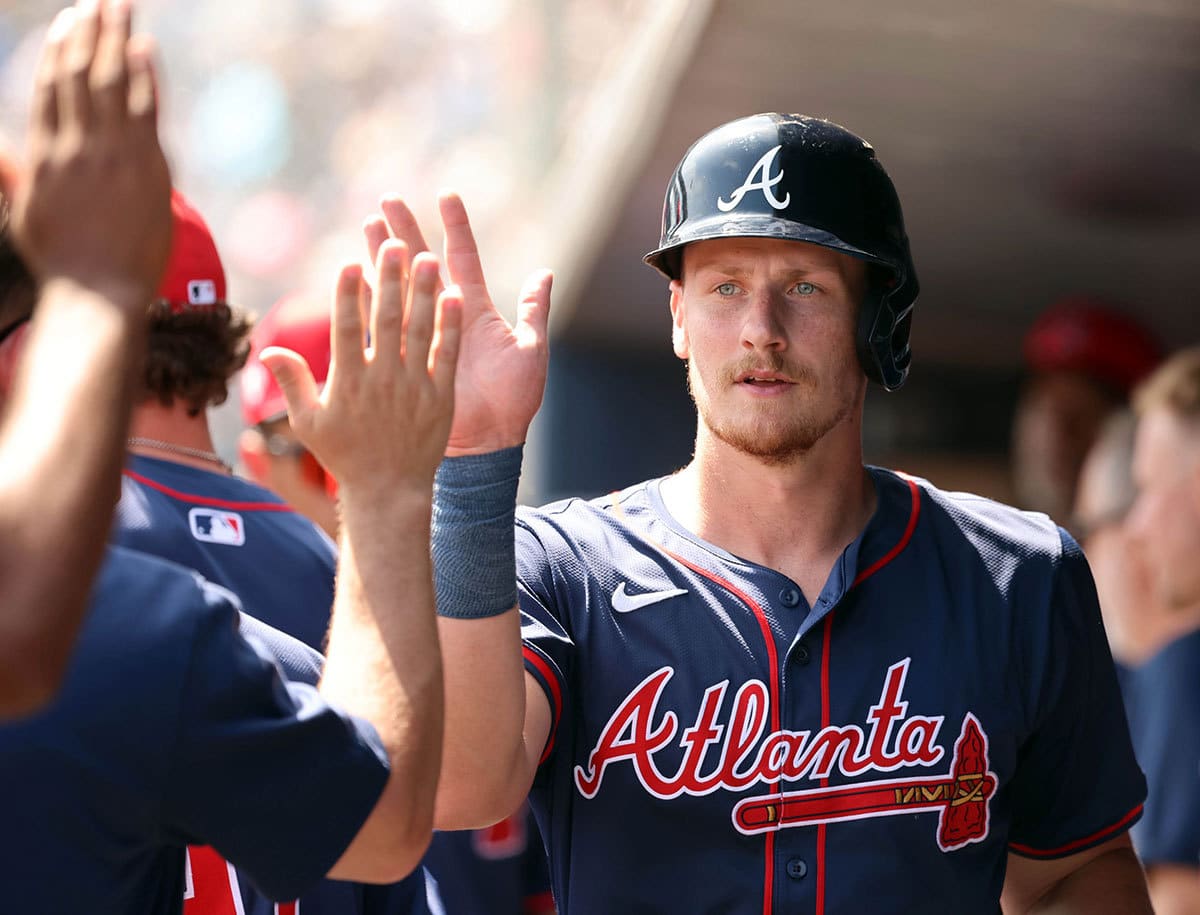 Atlanta Braves catcher Sean Murphy (12) is congratulated in the dugout after he scored during the first inning against the New York Yankees at George M. Steinbrenner Field