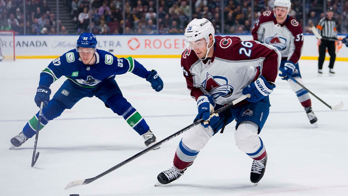 Vancouver Canucks forward Vasily Podkolzin (92) watches as Colorado Avalanche defenseman Sean Walker (26) handles the puck in the first period at Rogers Arena.