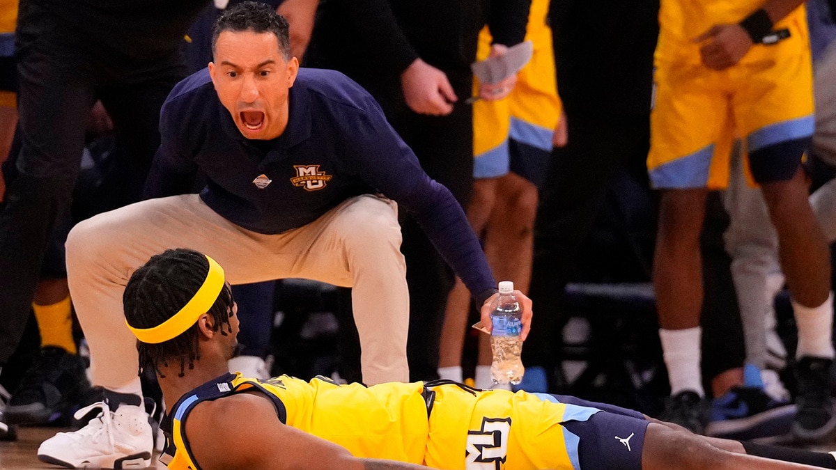 Marquette Golden Eagles head coach Shaka Smart cheers guard Chase Ross (2) after a basket during the second half at Madison Square Garden.