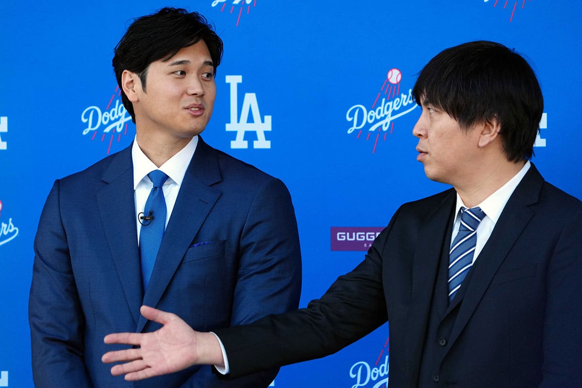 Los Angeles Dodgers designated hitter Shohei Ohtan (left) speaks to interpreter Ippei Mizuhara at introductory press conference at Dodger Stadium.