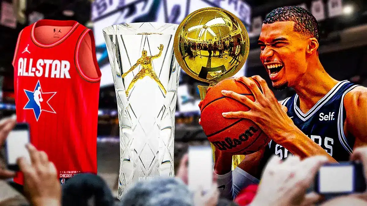Spurs' Victor Wembanyama smiling, with the Larry O’Brien trophy, MVP trophy (2023 glass version), and All-Star uniform falling beside him