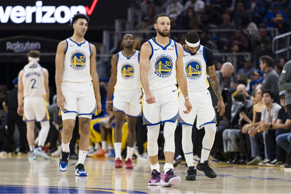 Golden State Warriors guard Stephen Curry (30) and guard Brandin Podziemski (2) and other players walk on the court after a time-out during the first half of the game against the New York Knicks at Chase Center.