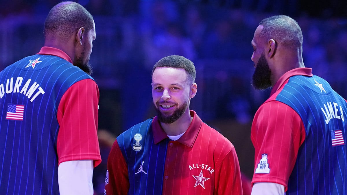 Western Conference guard Stephen Curry (30) of the Golden State Warriors talks with forward Kevin Durant (35) of the Phoenix Suns and forward LeBron James (23) of the Los Angeles Lakers before the 73rd NBA All Star game at Gainbridge Fieldhouse. 