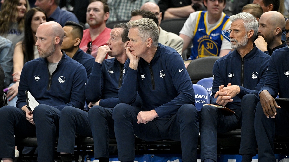 Golden State Warriors head coach Steve Kerr (center) sits on the team bench during the second half between the Dallas Mavericks and the Warriors at the American Airlines Center. 