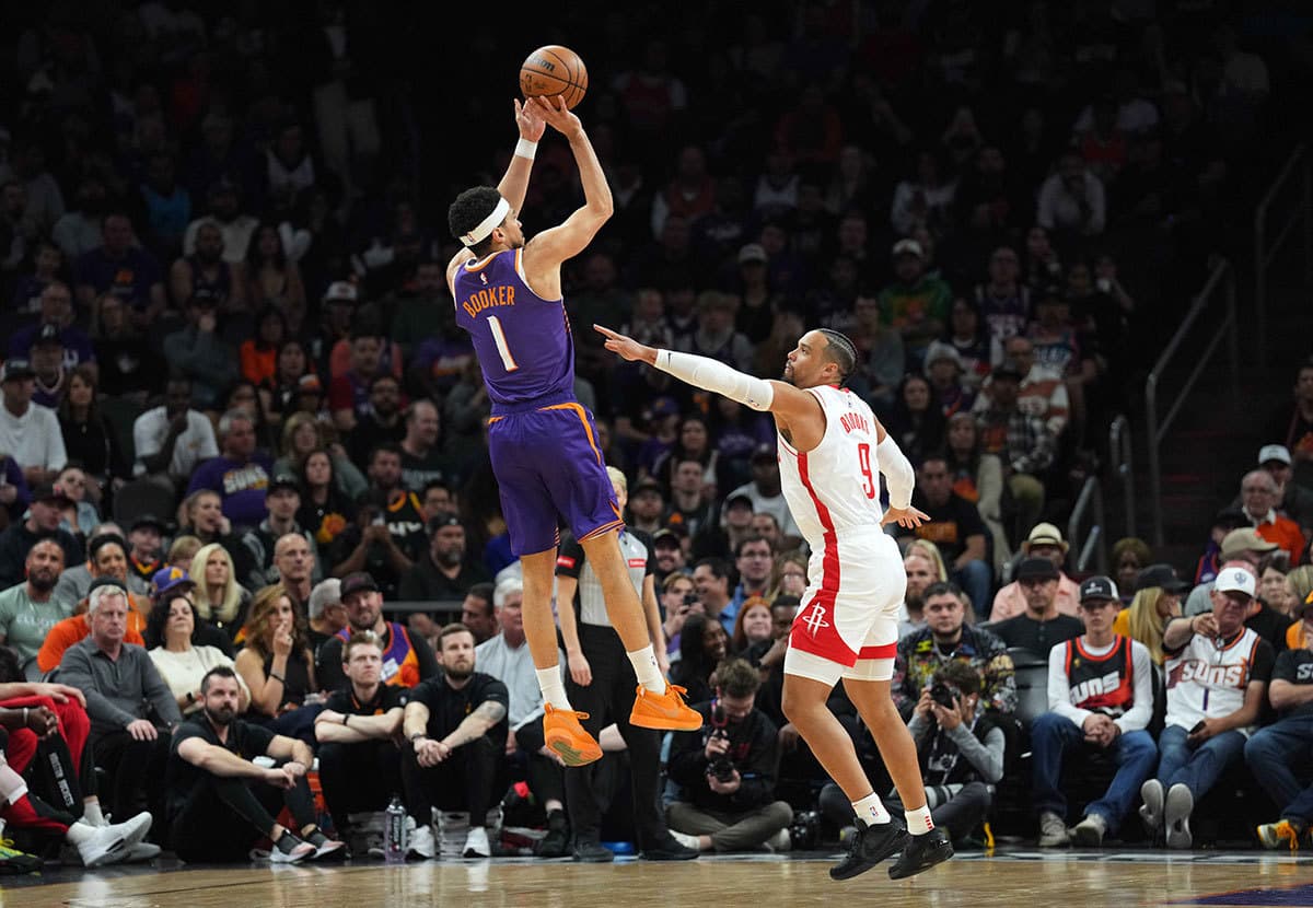 Phoenix Suns guard Devin Booker (1) shoots over Houston Rockets forward Dillon Brooks (9) during the first half at Footprint Center.