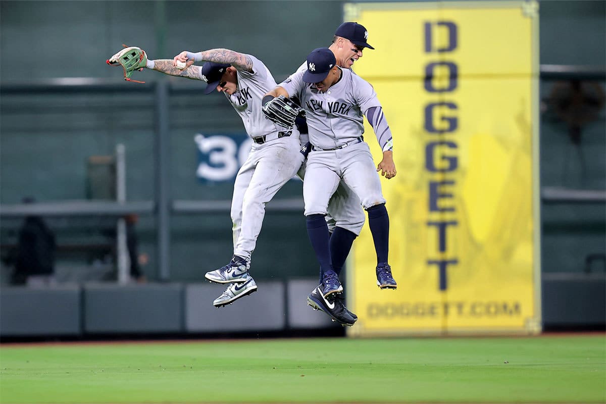 The New York Yankees outfielders celebrate after the final out against the Houston Astros during the ninth inning at Minute Maid Park. 