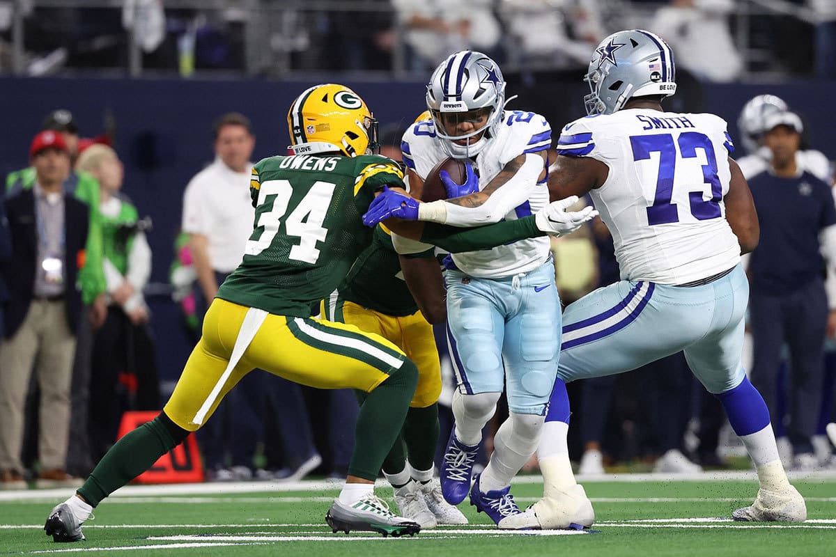 Green Bay Packers safety Jonathan Owens (34) tackles Dallas Cowboys running back Tony Pollard (20) in the first half of the 2024 NFC wild card game at AT&T Stadium