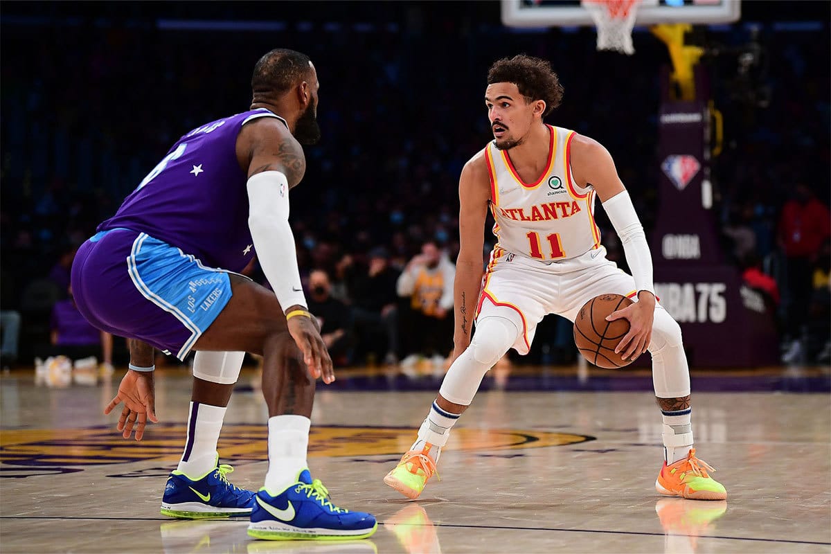 Atlanta Hawks guard Trae Young (11) controls the ball against Los Angeles Lakers forward LeBron James (6) during the first half at http://Crypto.com Arena. 