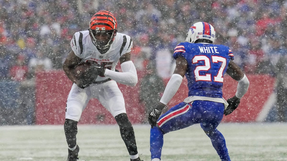 Cincinnati Bengals wide receiver Tee Higgins (85) jukes against Buffalo Bills cornerback Tre'Davious White (27) on a catch in the first quarter of the NFL divisional playoff football game between the Cincinnati Bengals and the Buffalo Bills, Sunday, Jan. 22, 2023, at Highmark Stadium in Orchard Park