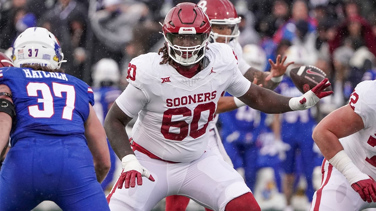 Oklahoma Sooners offensive lineman Tyler Guyton (60) at the line of scrimmage against the Kansas Jayhawks during the game at David Booth Kansas Memorial Stadium