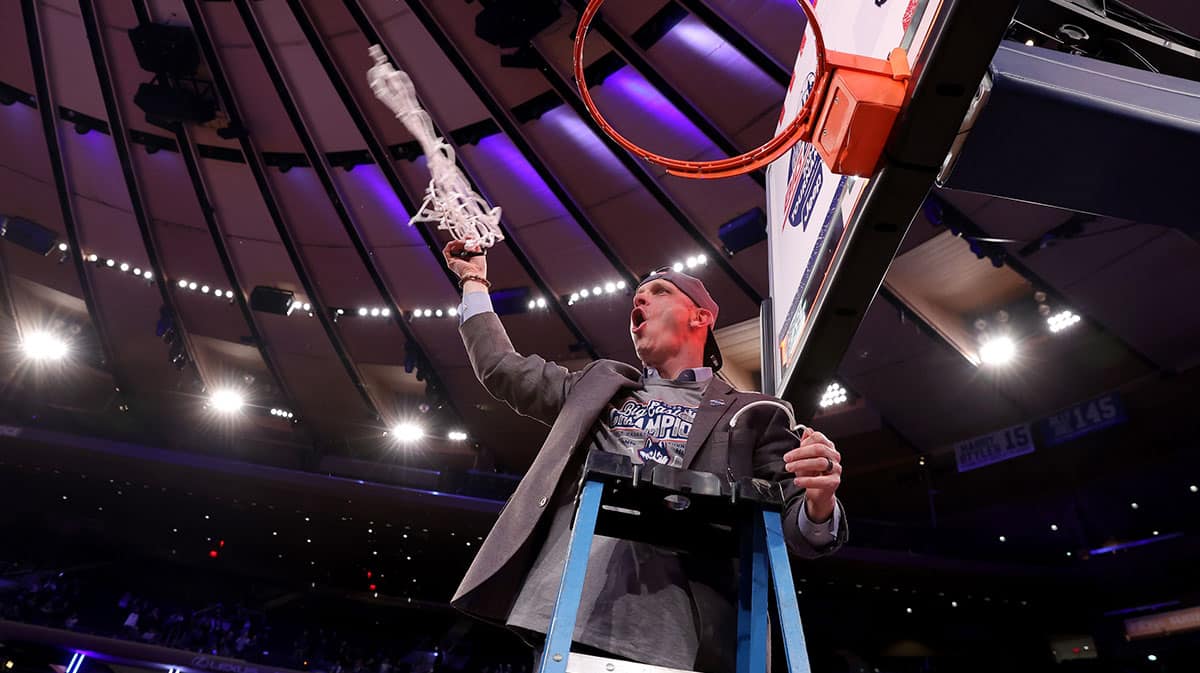 Connecticut Huskies head coach Dan Hurley cuts down the net after defeating the Marquette Golden Eagles to win the Big East conference tournament at Madison Square Garden.