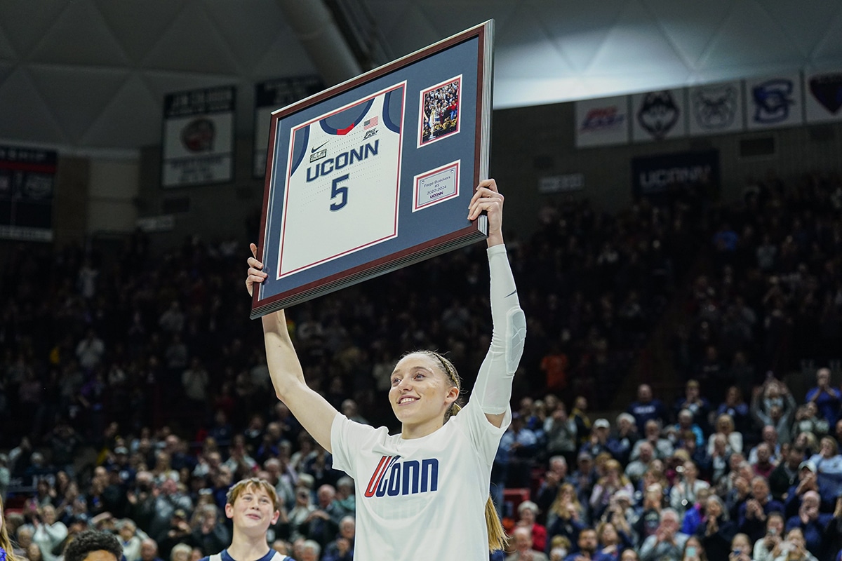 UConn Huskies guard Paige Bueckers (5) holds up her jersey during senior night after defeating the Georgetown Hoyas 