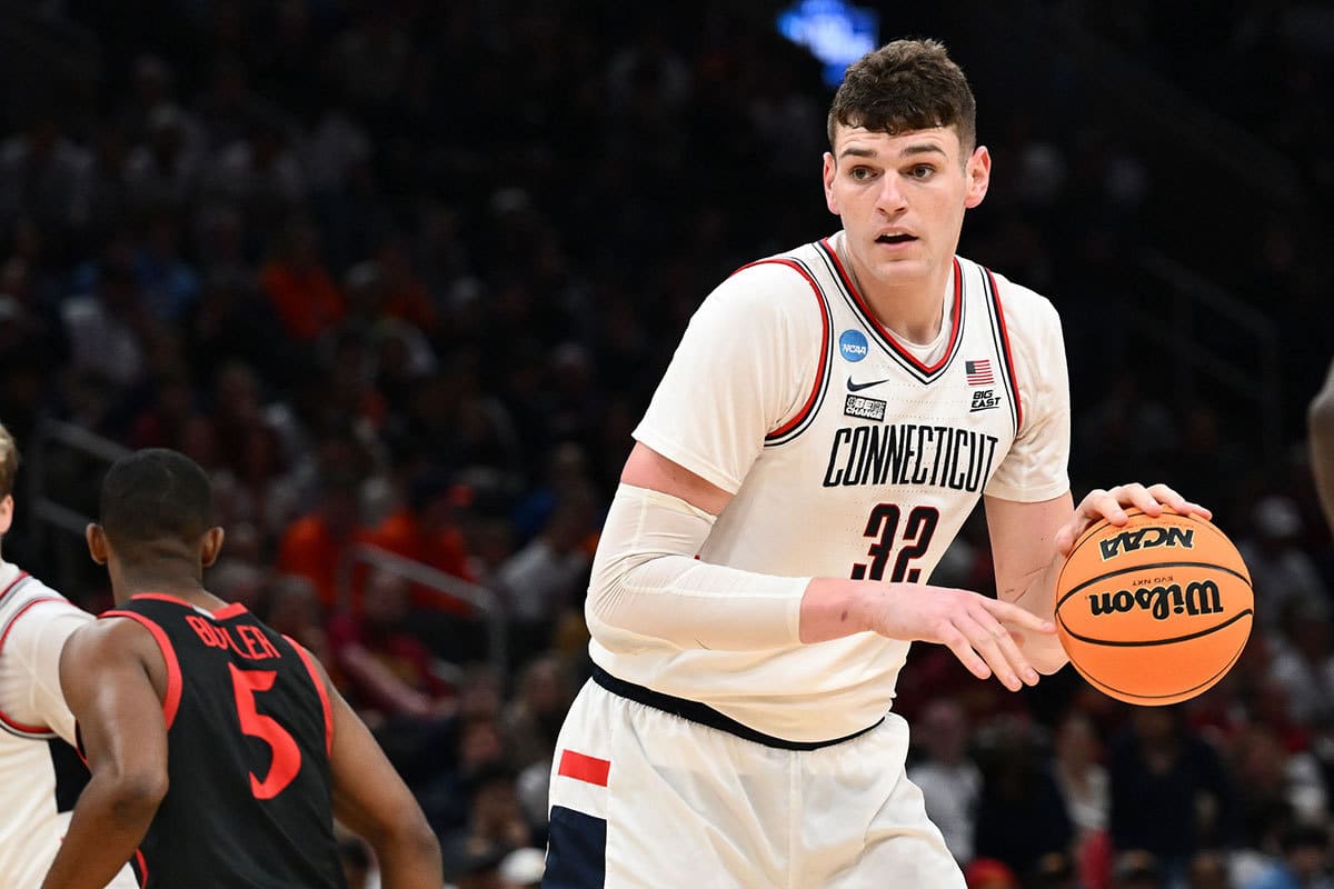 Connecticut Huskies center Donovan Clingan (32) dribbles the ball against the San Diego State Aztecs in the semifinals of the East Regional of the 2024 NCAA Tournament at TD Garden.