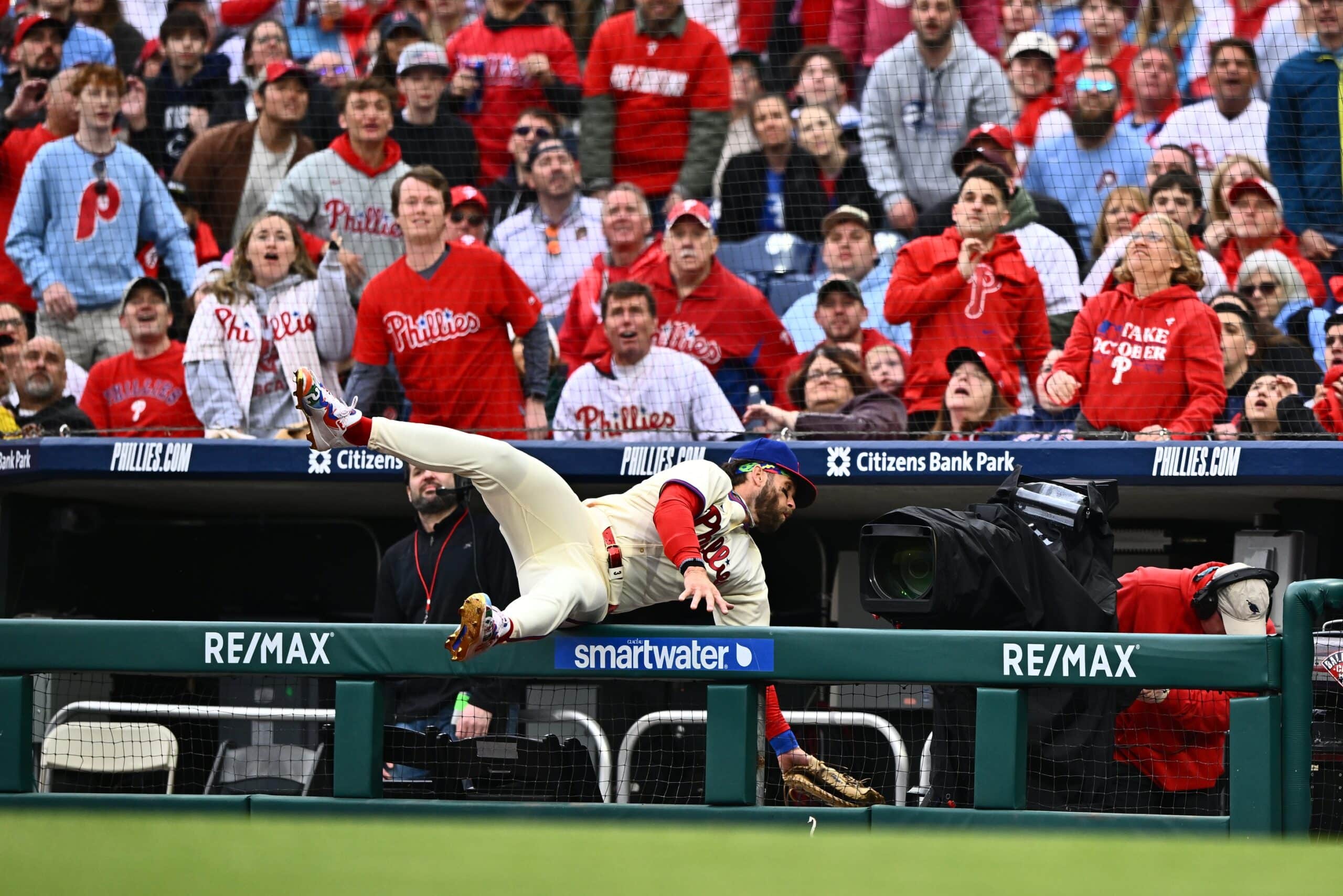 Philadelphia Phillies first baseman Bryce Harper (3) falls into the dugout attempting to catch a foul ball against the Atlanta Braves in the first inning at Citizens Bank Park.