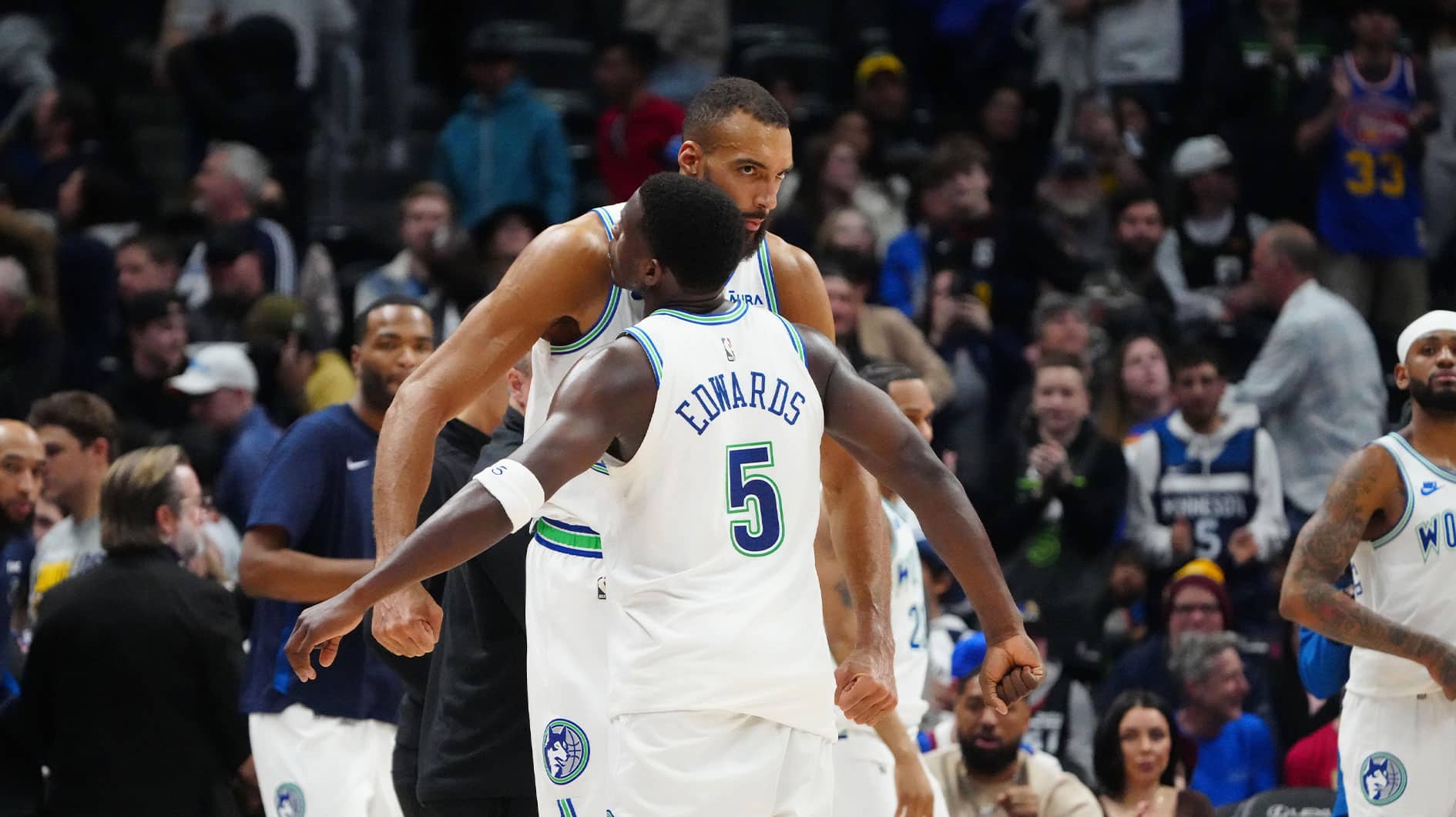 Minnesota Timberwolves center Rudy Gobert (27) and guard Anthony Edwards (5) celebrate defeating the Denver Nuggets at Ball Arena.