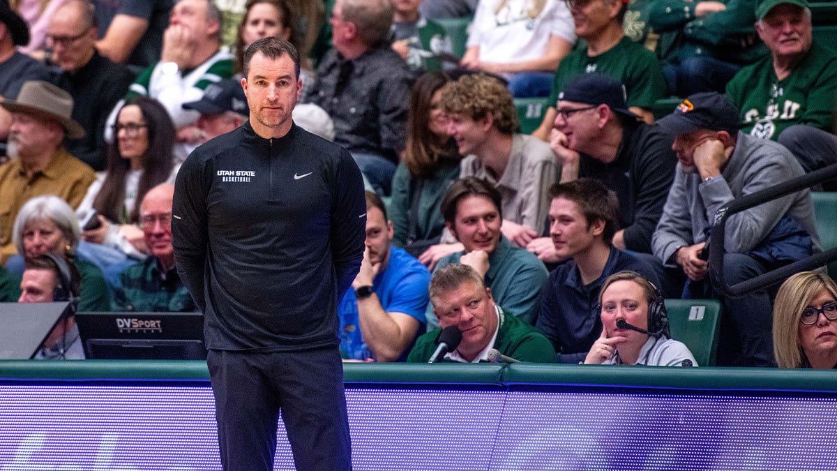 Utah State basketball head coach Danny Sprinkle stares off into the distance after a turnover in a blowout loss against Colorado State at Moby Arena on Saturday, Feb. 17, 2024 in Fort Collins, Colo.