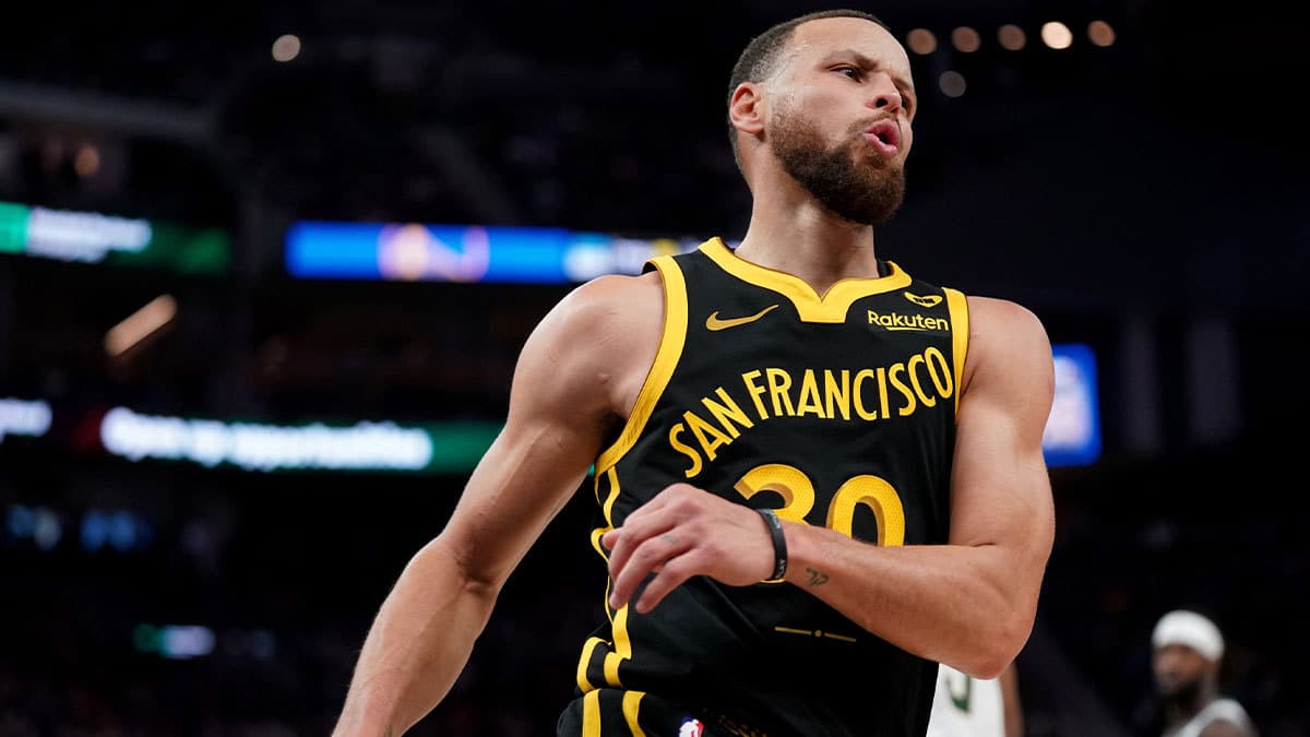 Golden State Warriors guard Stephen Curry (30) reacts after recording an assist against the Milwaukee Bucks in the third quarter at the Chase Center