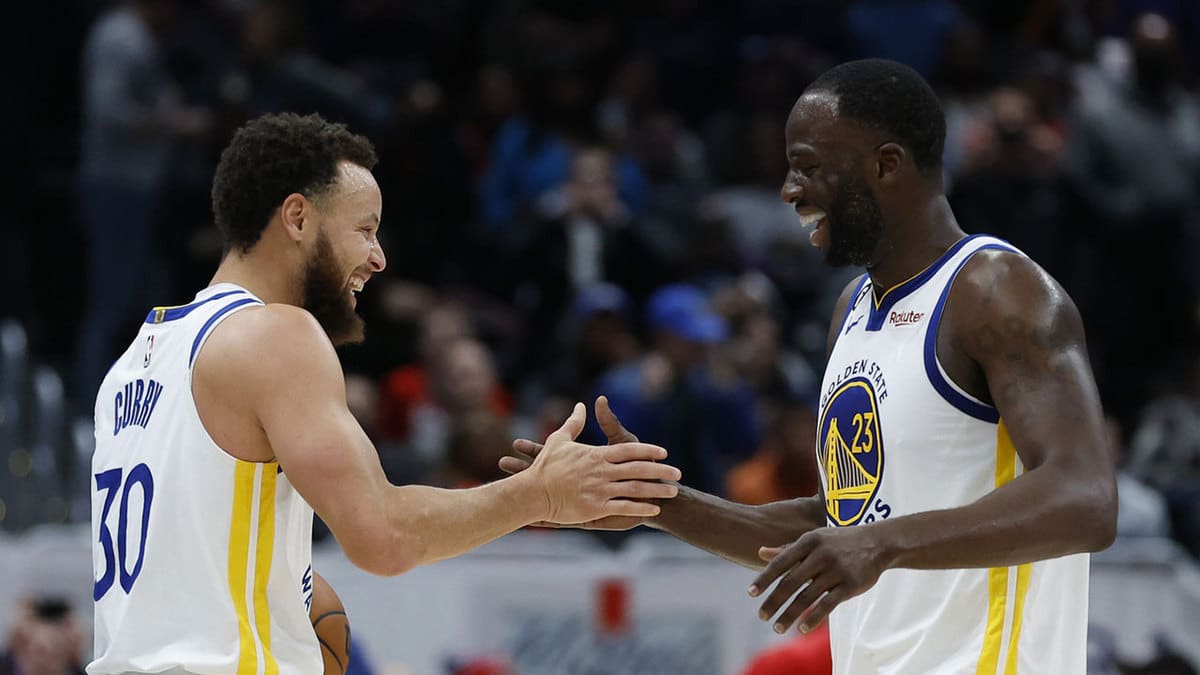 Golden State Warriors guard Stephen Curry (30) celebrates with Warriors forward Draymond Green (23) after their game against the Washington Wizards at Capital One Arena
