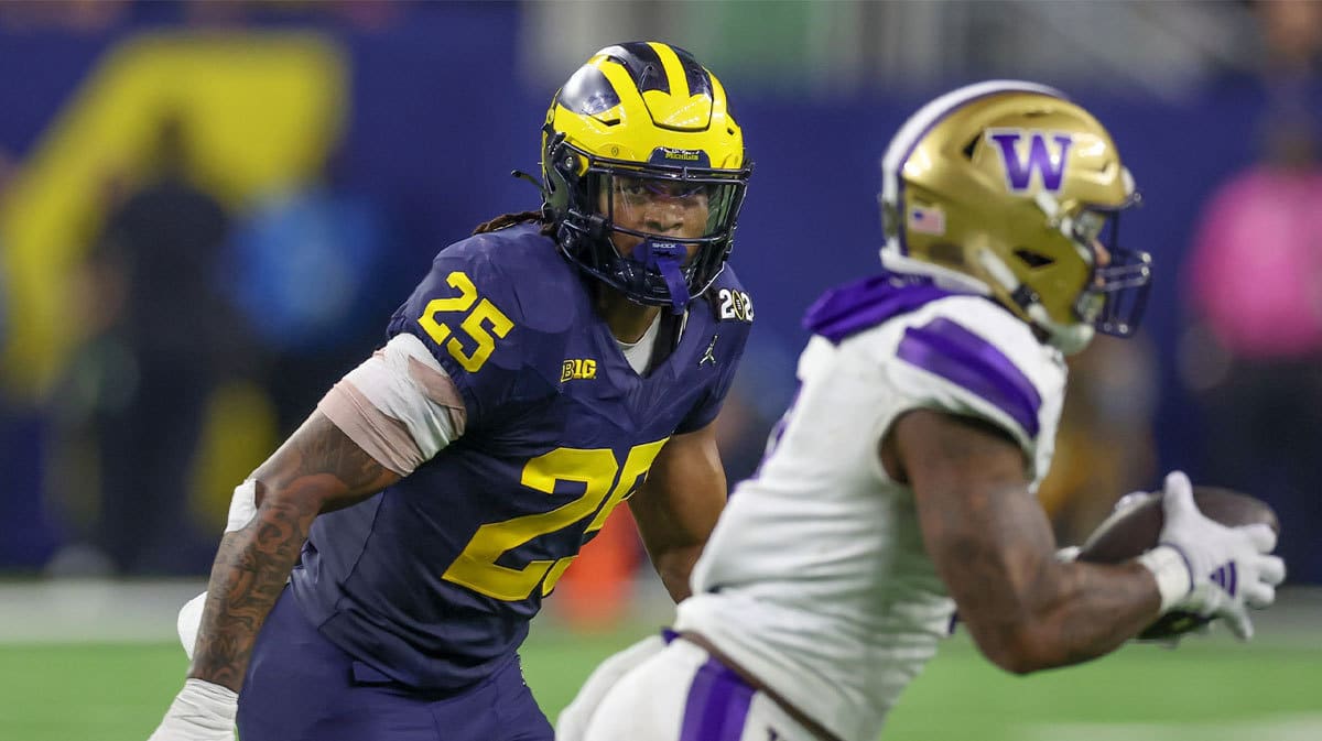 Washington Huskies quarterback Michael Penix Jr. (9) is chased by Michigan Wolverines linebacker Junior Colson (25) in the 2024 College Football Playoff national championship game at NRG Stadium.