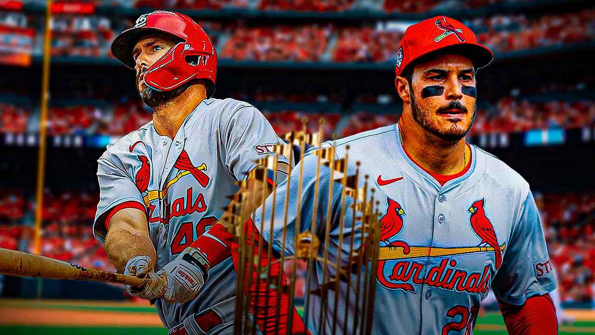 Cardinals' Nolan Arenado, Cardinals' Paul Goldschmidt smiling next to the MLB World Series trophy.